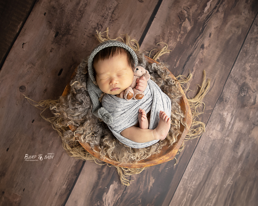 Beautiful newborn portrait of baby wrapped in cashmere at Croydon newborn photography studio.