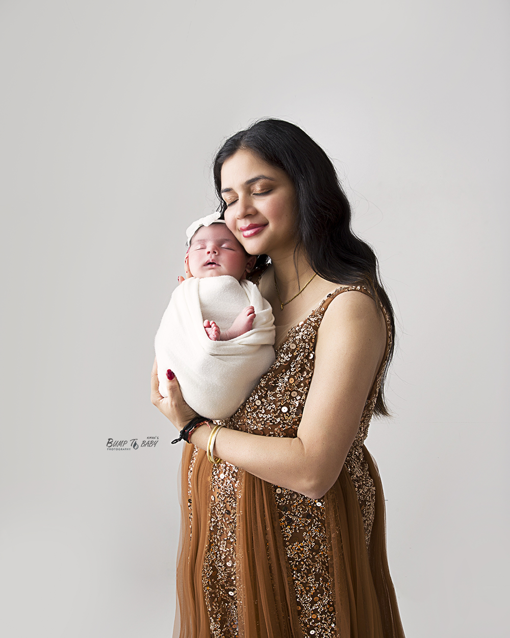 Tender moment of mum embracing newborn baby in Croydon Melbourne photography studio