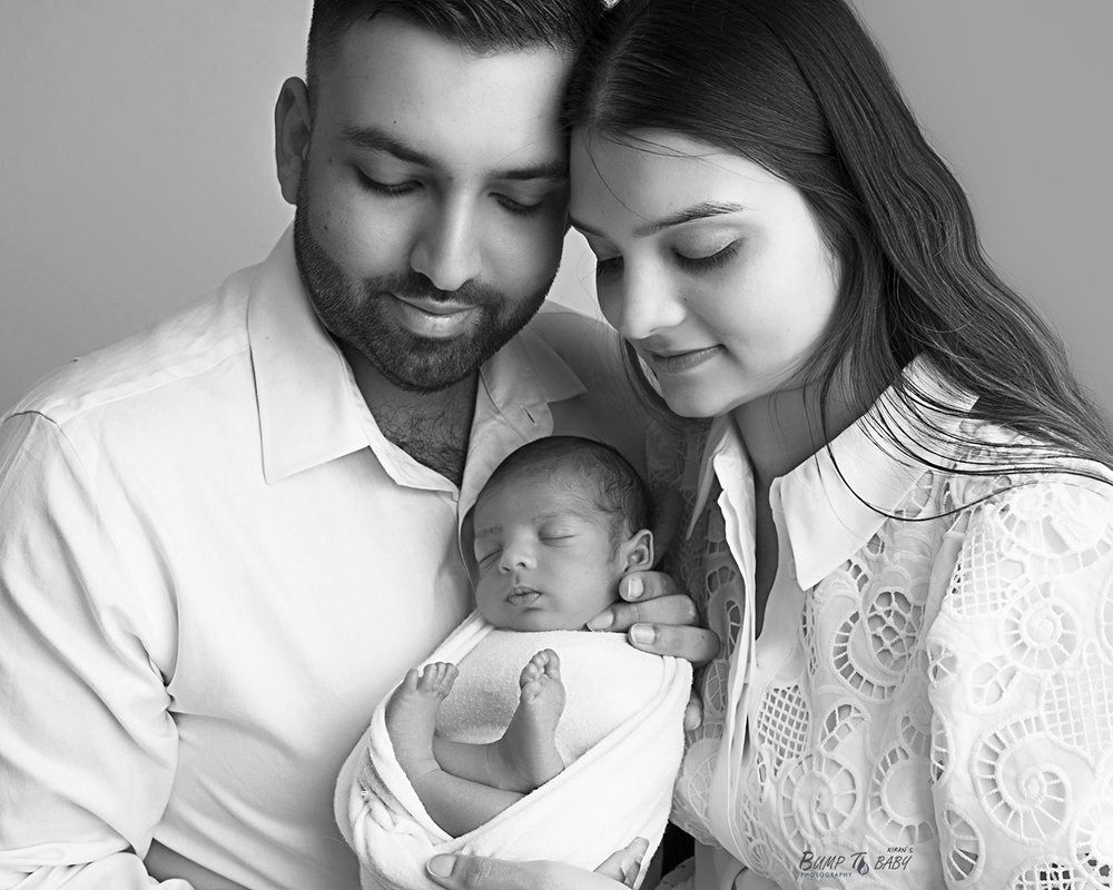 Mum and dad holding newborn baby in Croydon Melbourne studio