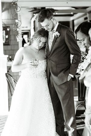 Black and white photo of bride and groom sharing an intimate moment at their wedding reception at wolf mountain vineyards