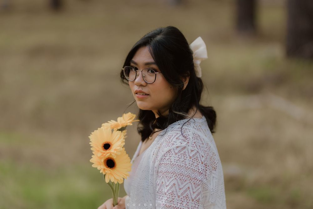 Multiple images of couple posing with bright yellow sunflowers in a countryside setting wearing white lace.