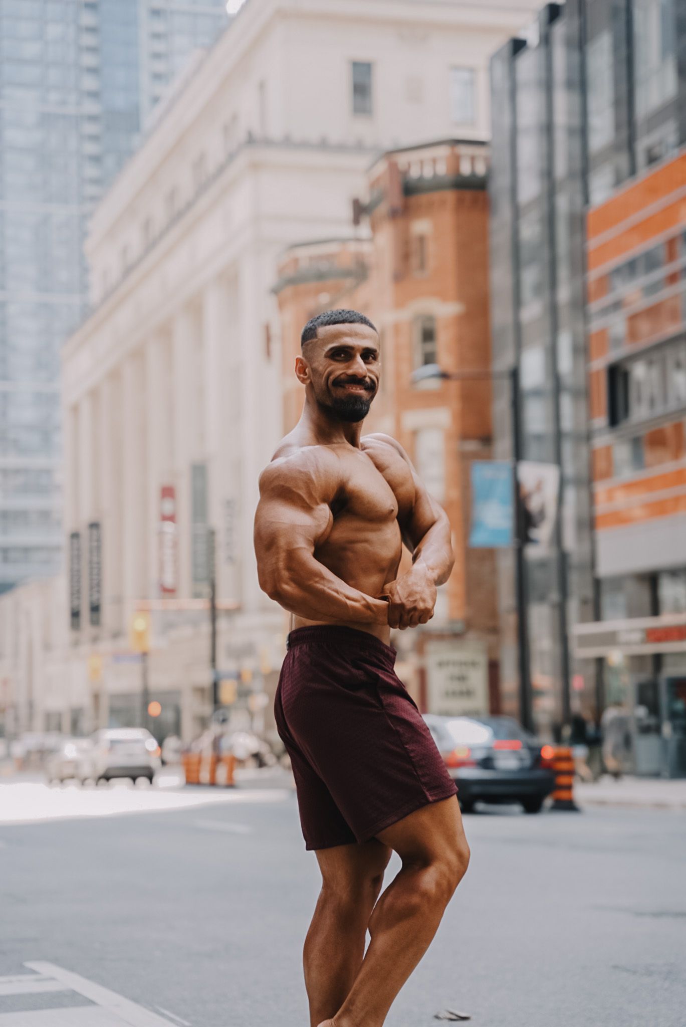 Full-body photo of fitness model standing in power pose