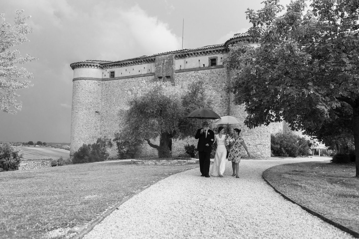 Elegant castle exterior with curved driveway leading to entrance on wedding day.