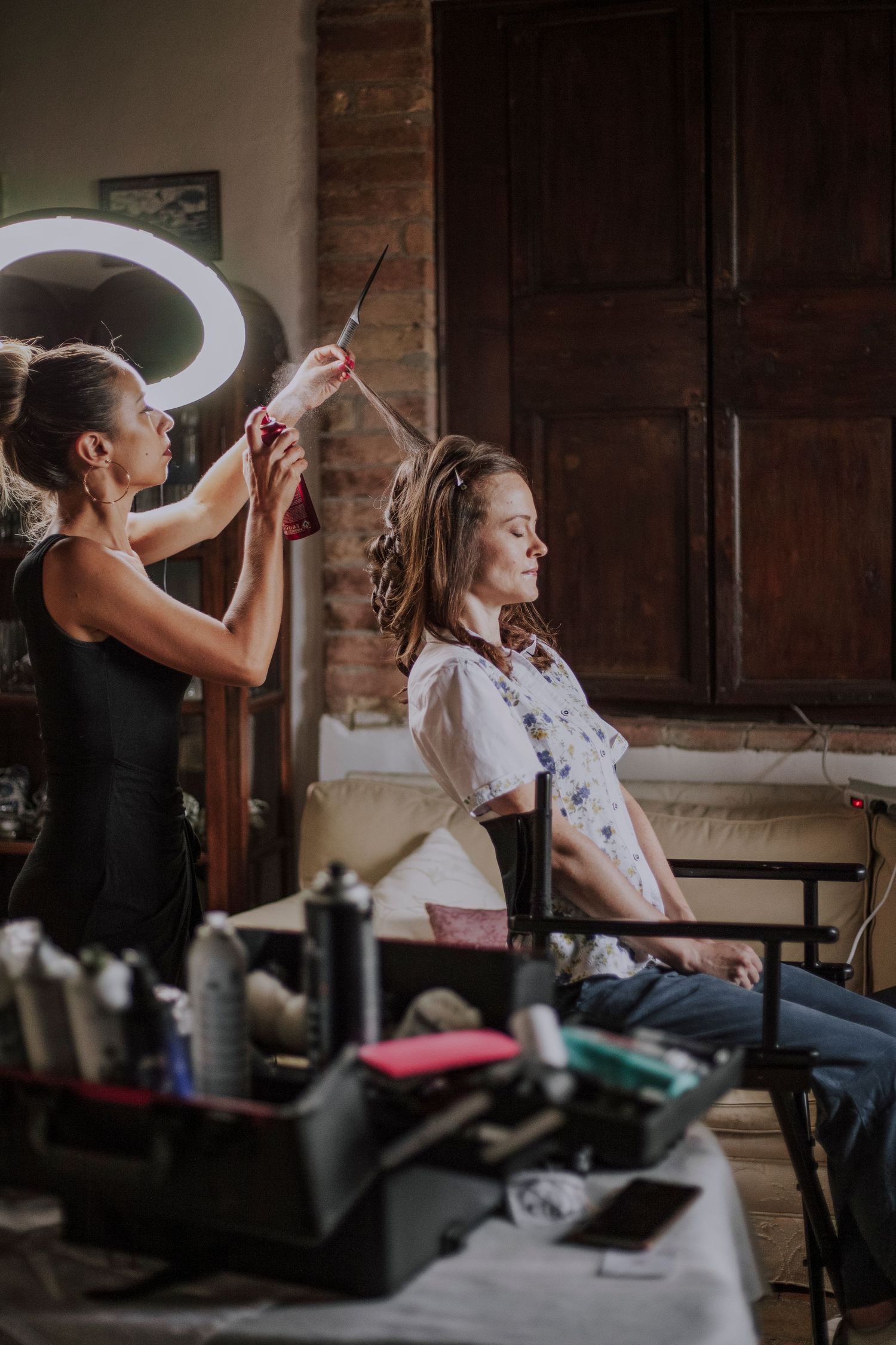 Wedding preparation scene in a rustic room with vintage furniture and natural lighting.