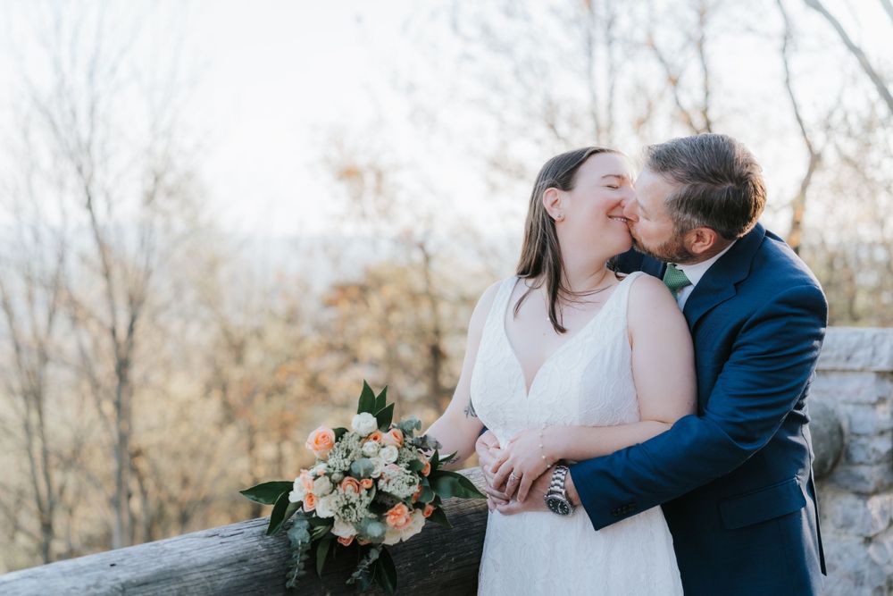 Romantic moment between newlyweds embracing outdoors.