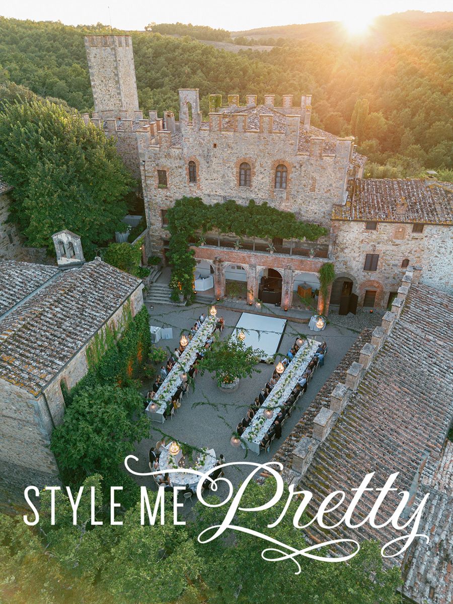 Aerial view of a stunning Castello di Montalto courtyard wedding reception at golden hour, featured on Style Me Pretty.