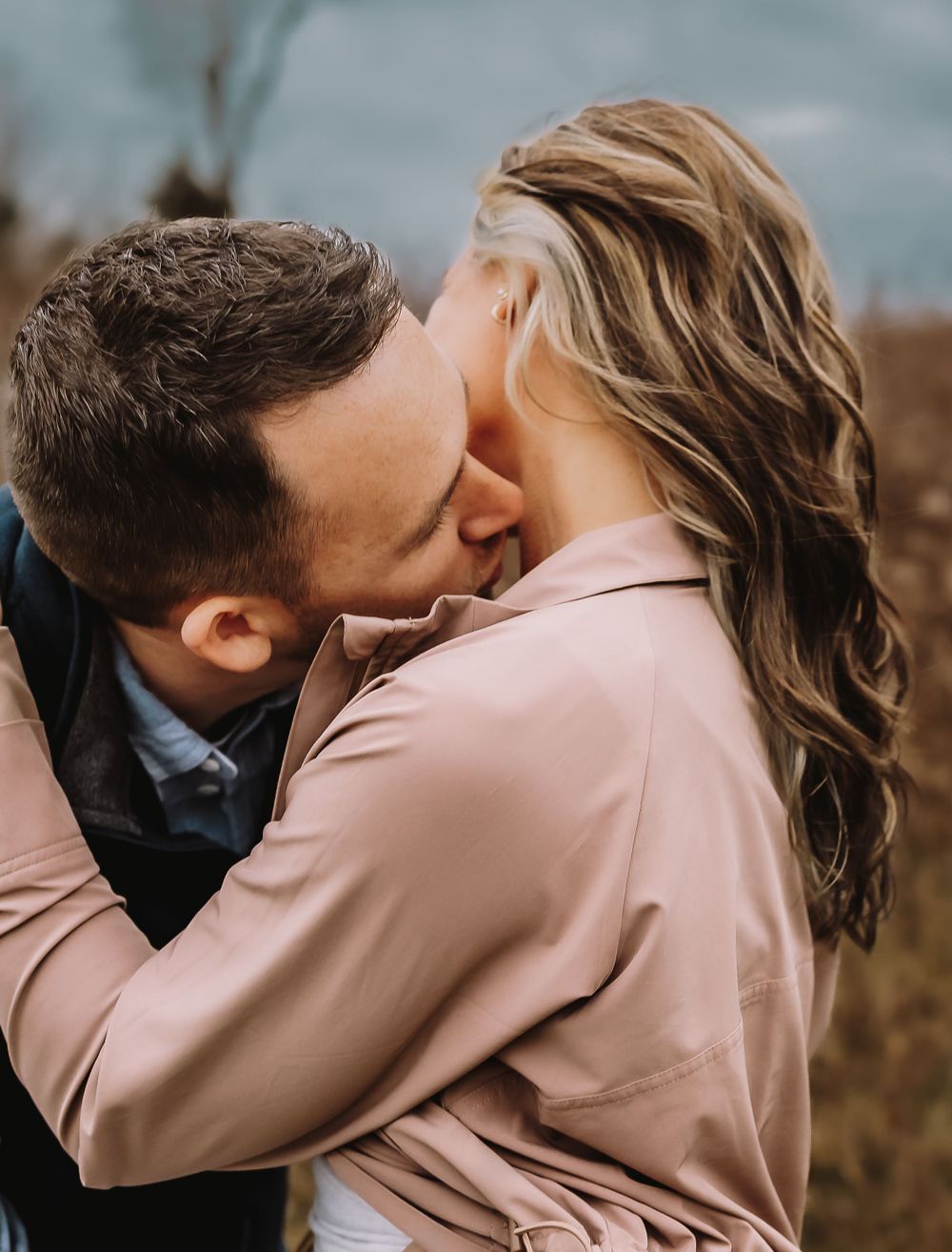 A couple in formal attire share intimate kisses in a series of romantic outdoor photographs.
