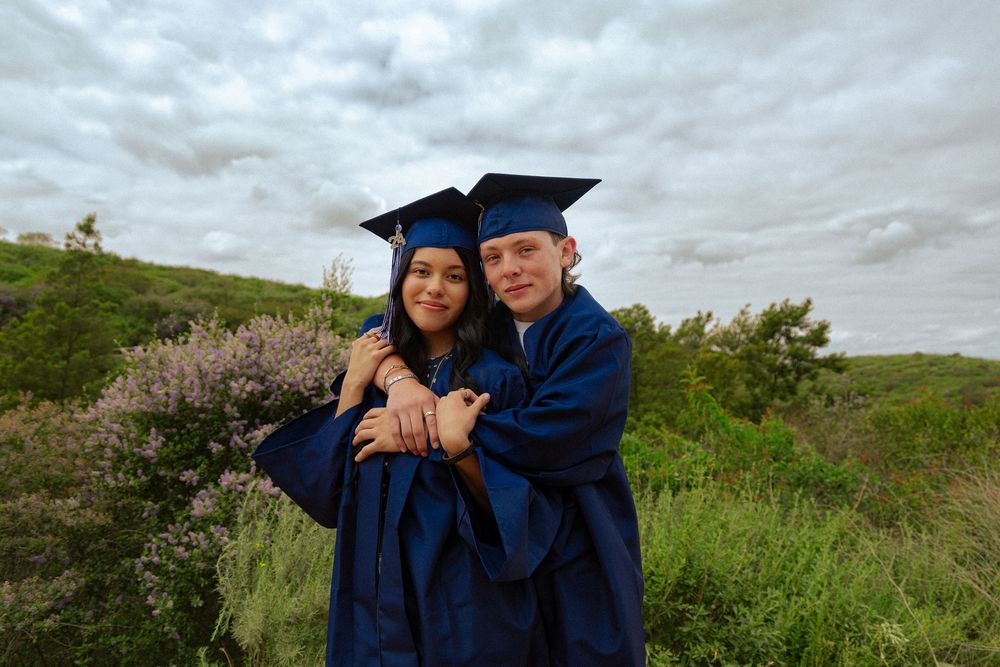 A group of graduation photos featuring graduates in blue caps and gowns posing outdoors on a cloudy day.
