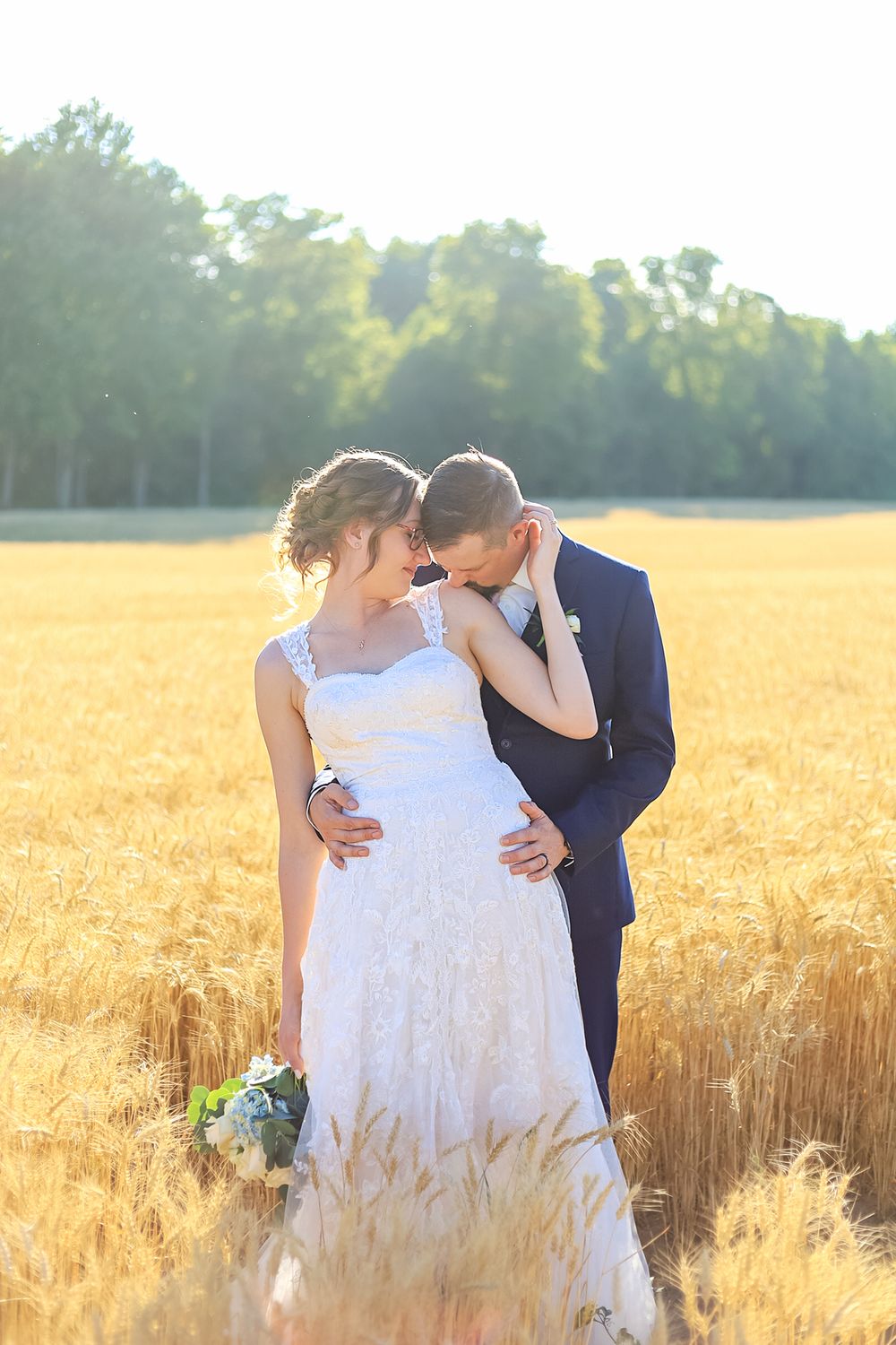 Intimate wedding photos taken in a sun-drenched wheat field during golden hour at Knottingwood in Ilderton.
