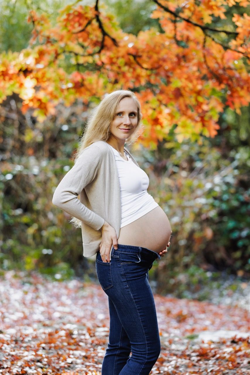 Expecting mother posing in a Snohomish field at sunset. Warm and intimate maternity photography by Tim Neal.