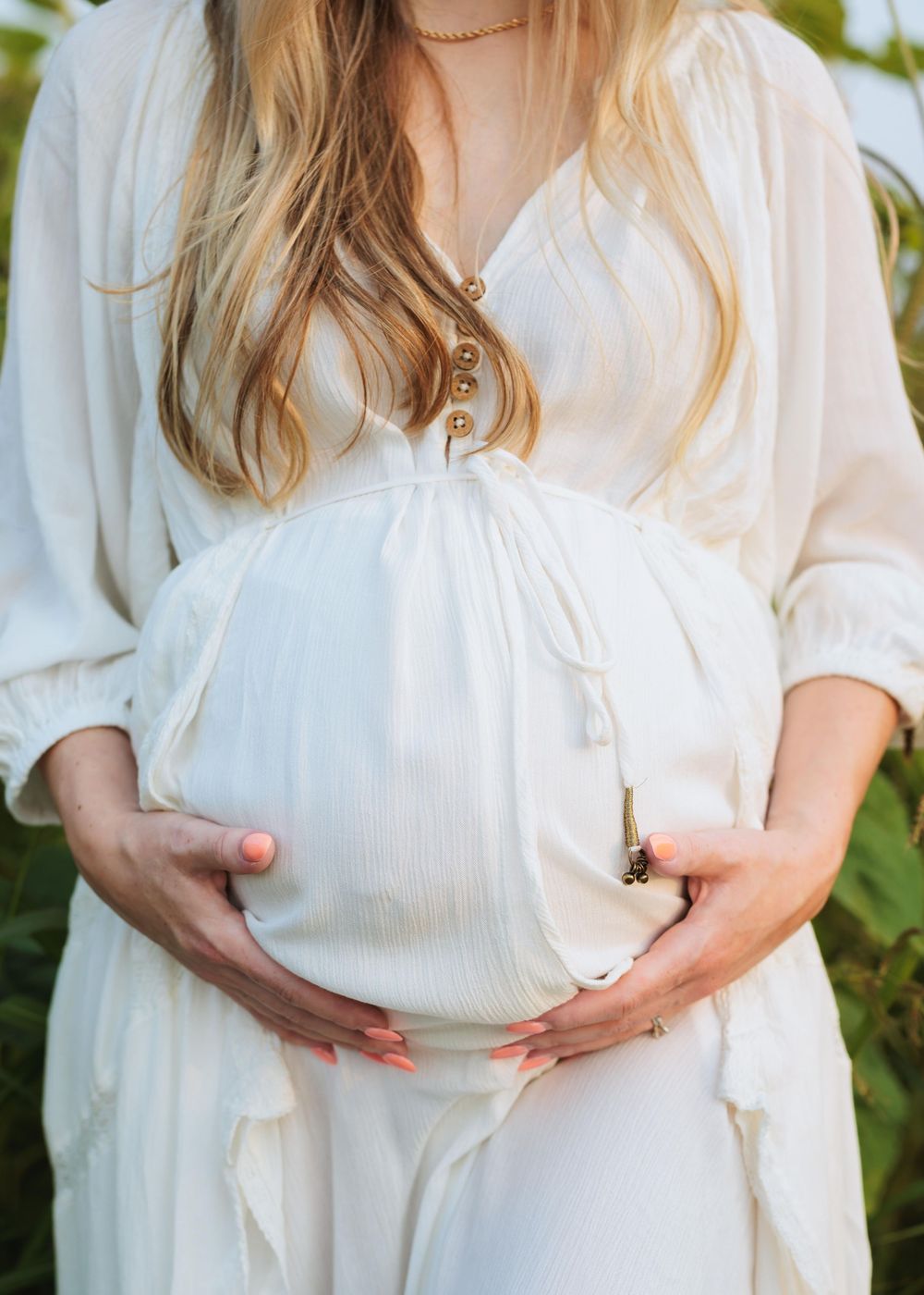 Close-up of mother holding her baby bump. Affectionate motherhood storytelling in Lake Stevens WA by Tim Neal.