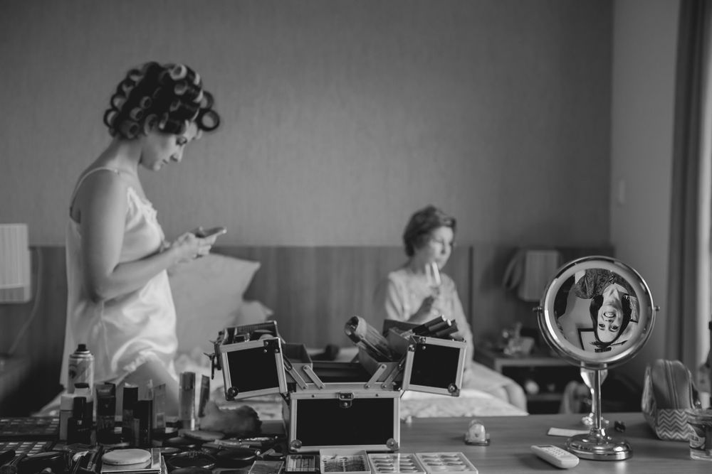 Black and white image of getting ready preparations with beauty supplies on a table.