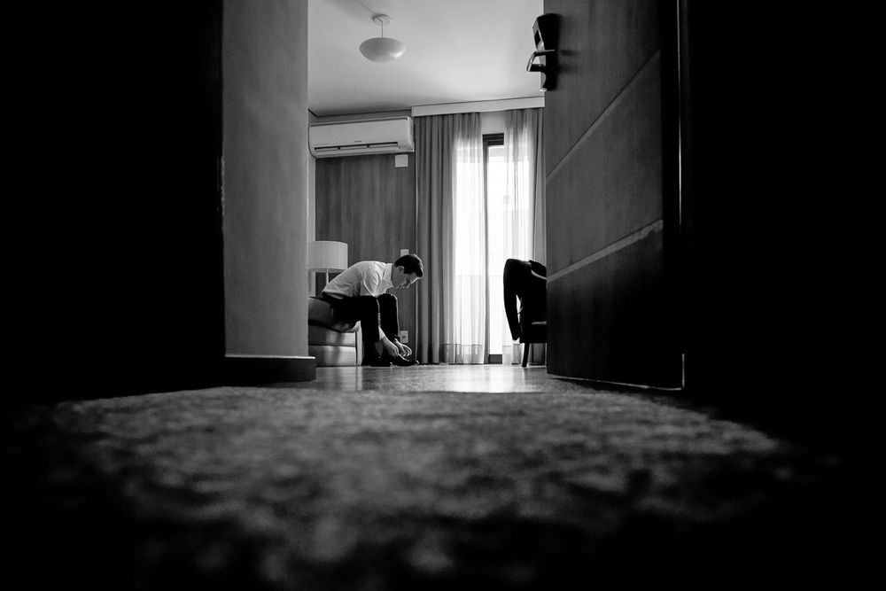 Atmospheric black and white corridor shot with window light streaming in.