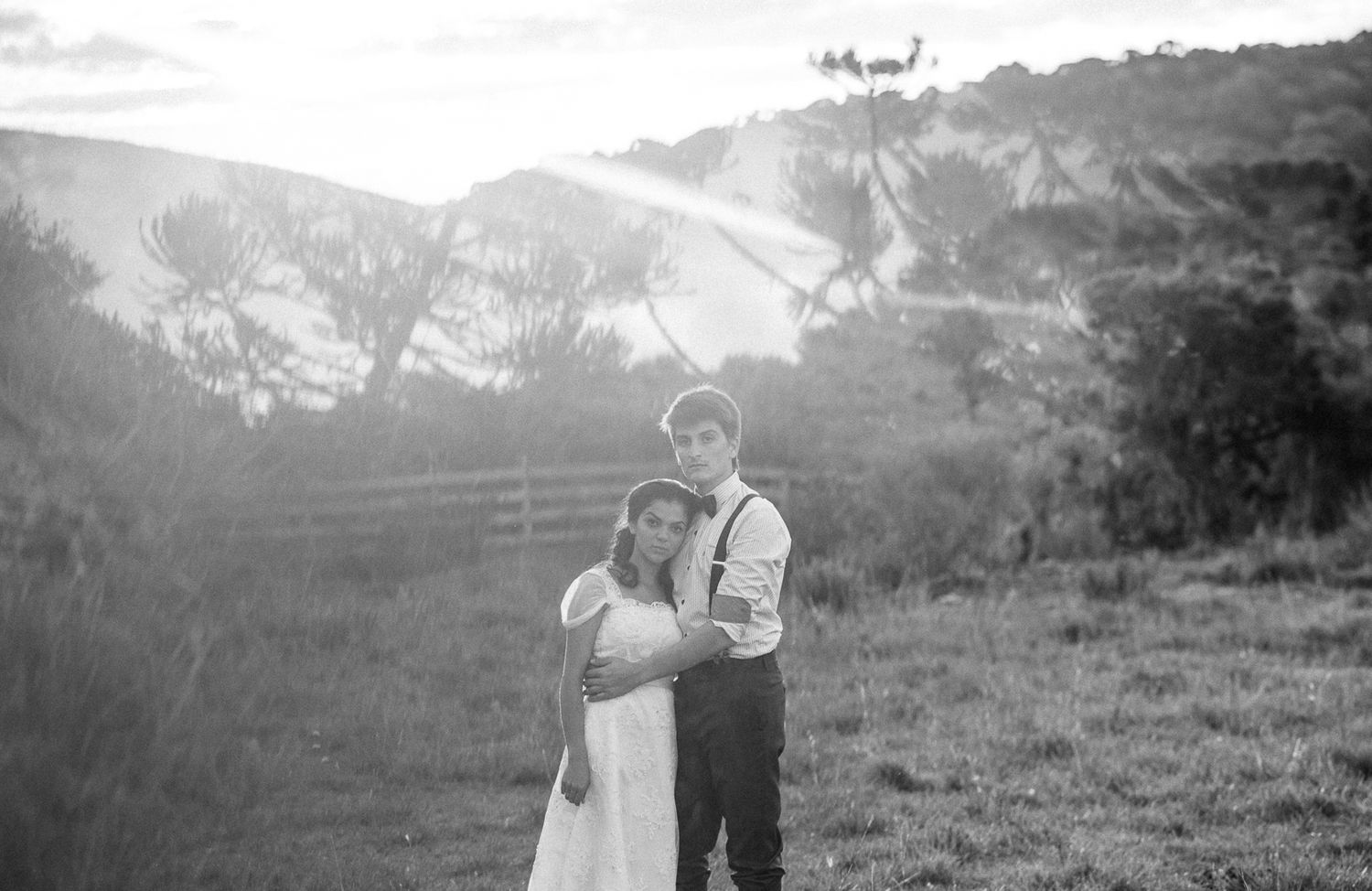 A romantic mountain wedding scene with dramatic landscapes in black and white.
