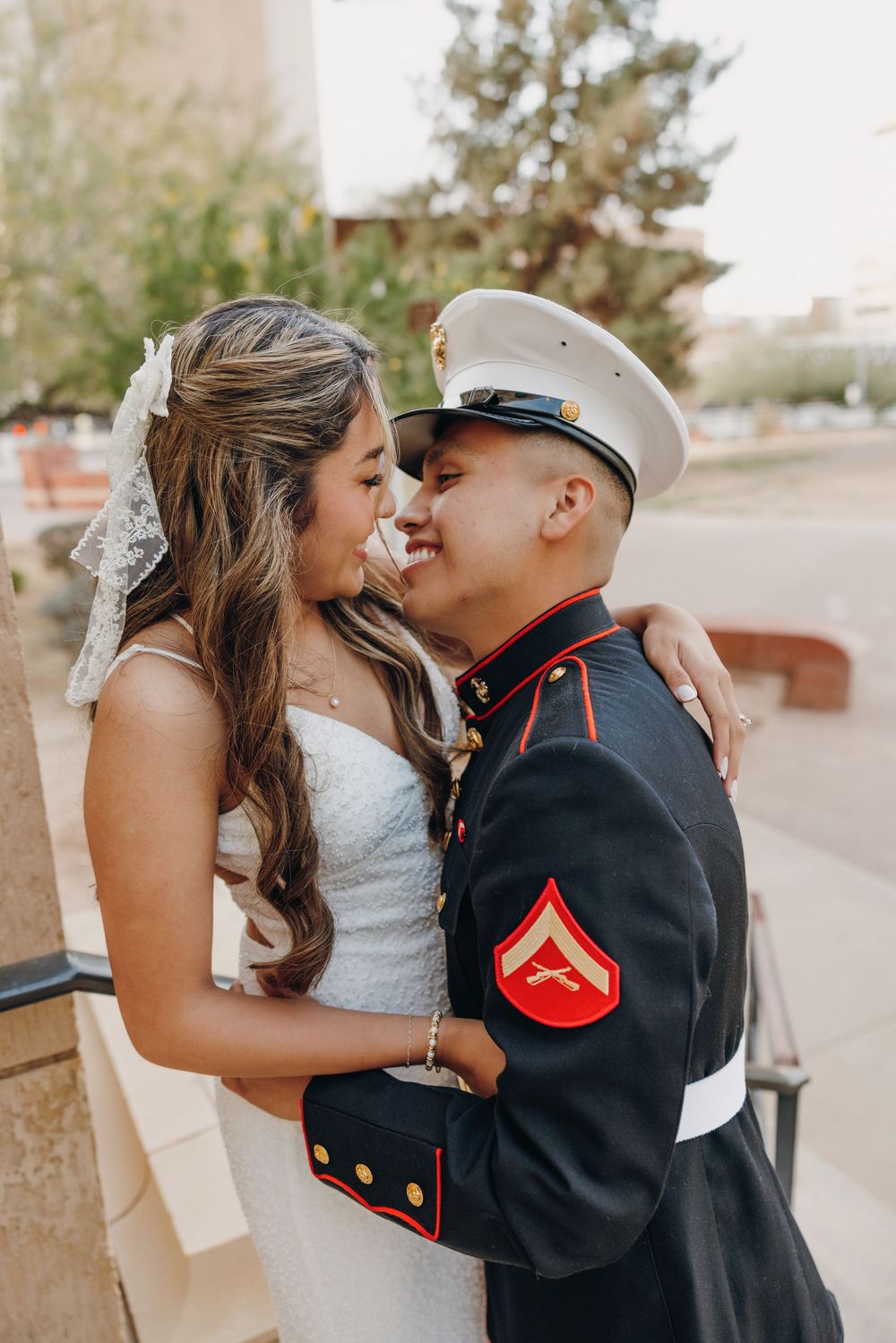 A romantic wedding photo series showing tender kisses between a bride in white and a Marine in dress uniform.