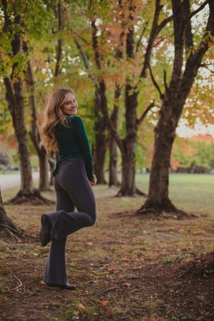A series of outdoor portraits in a wooded area with fall foliage and scattered leaves.
