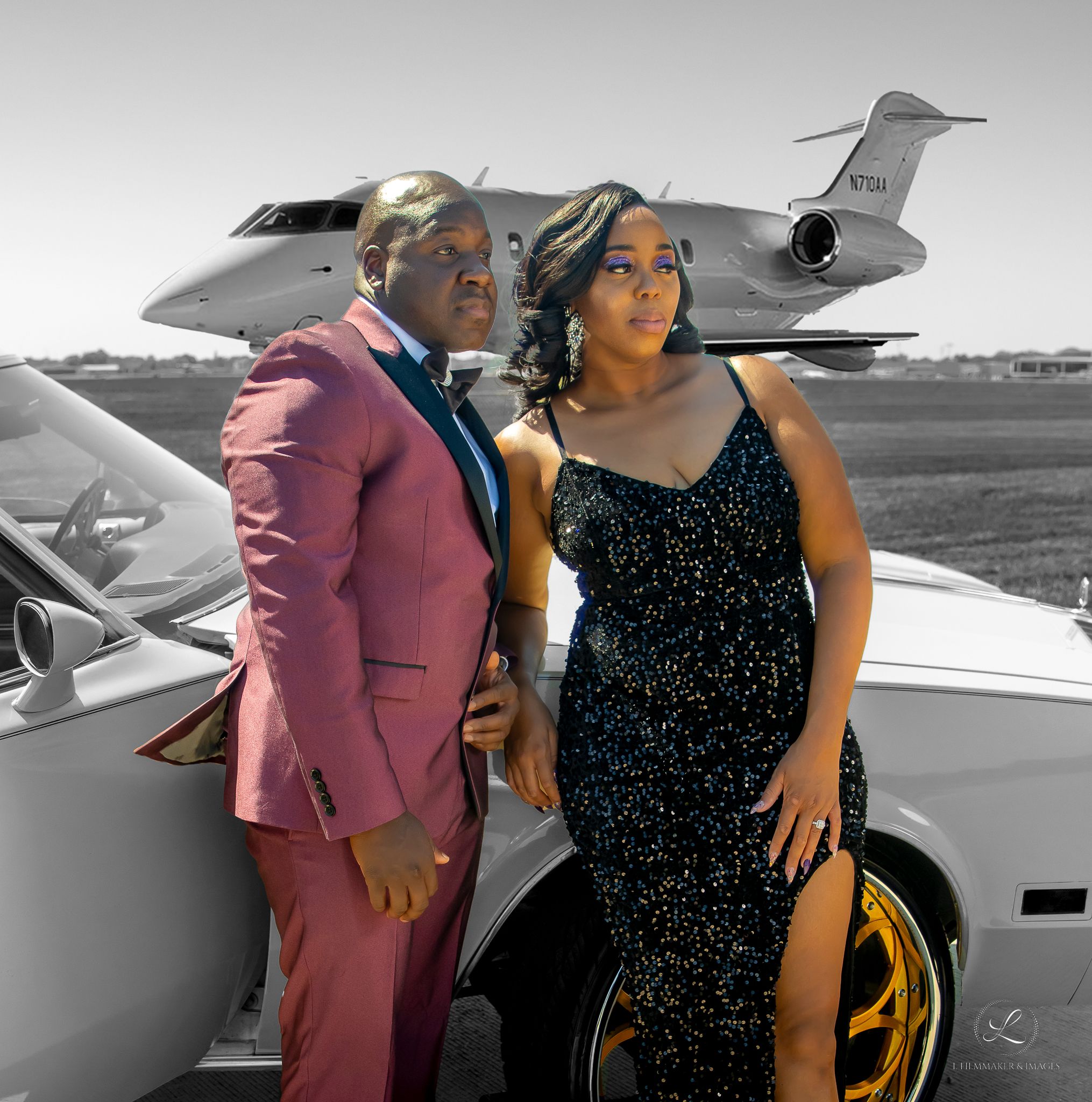 Glamorous couple in formal wear pose beside a private jet and luxury car in stylized photo.