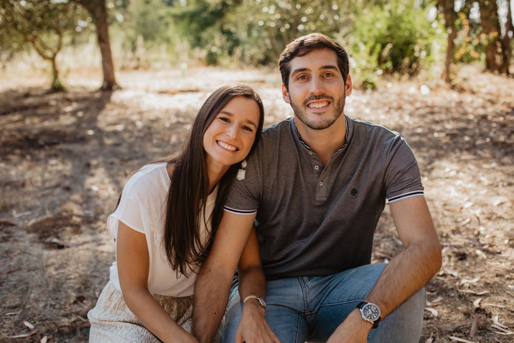 Casual outdoor couple's portrait session showing natural laughing moments under trees.