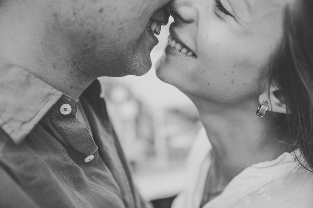 Intimate black and white close-up shots showing tender moments between two people.