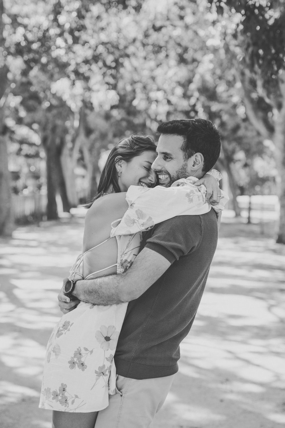 Black and white photo series capturing playful dancing movements in a park setting.