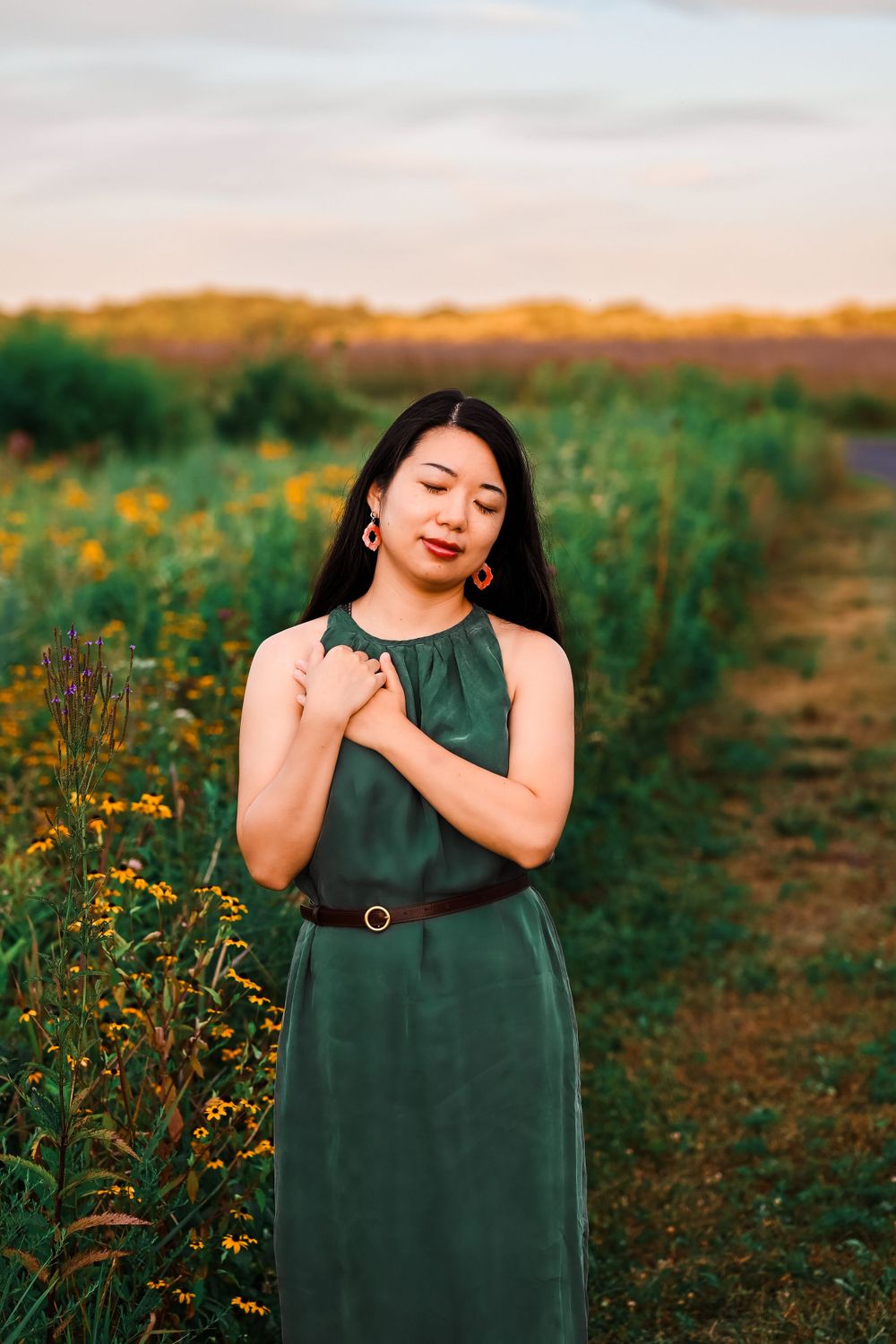Young woman clutches heart at Prophetstown State Park.