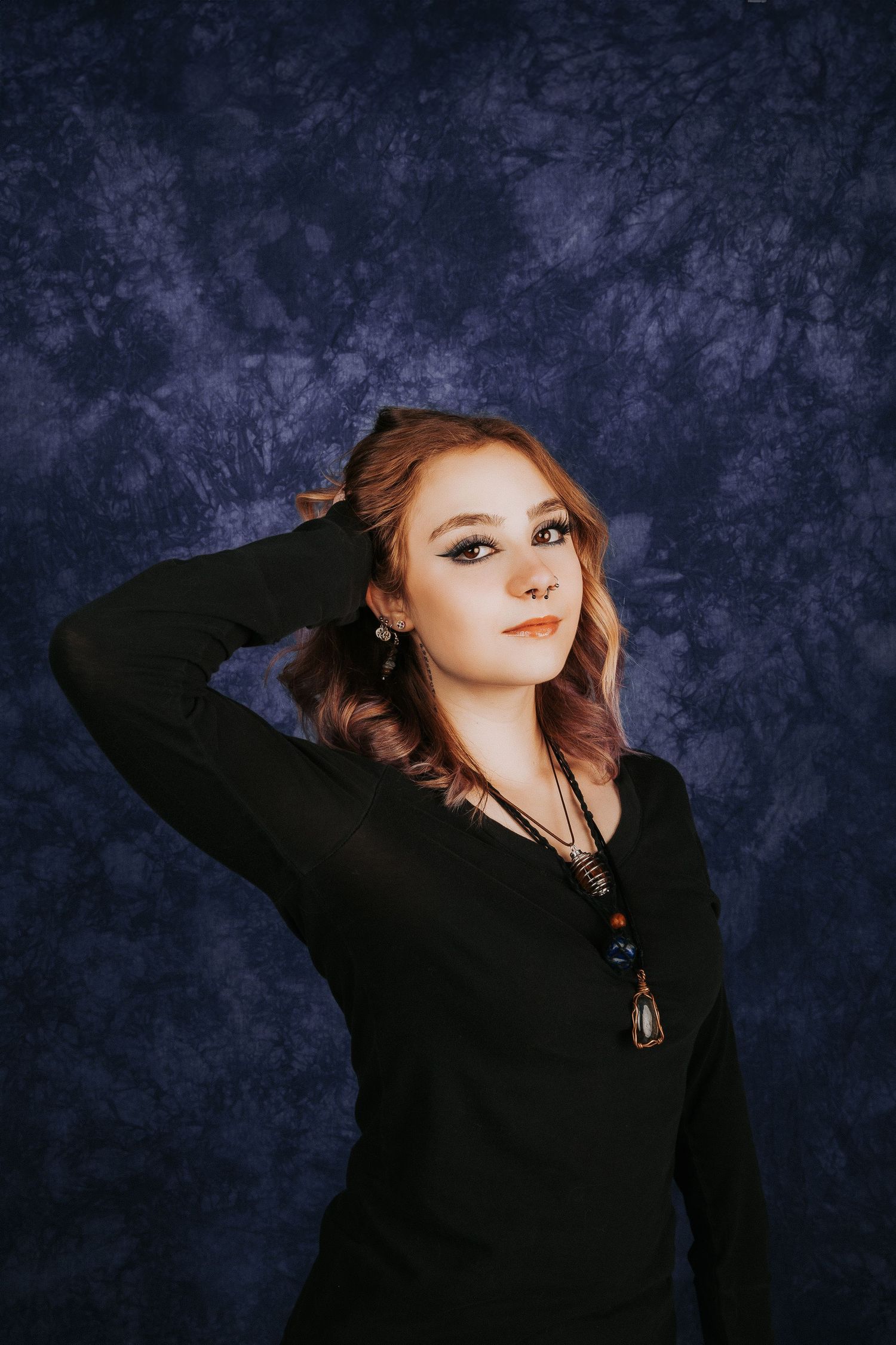 Portrait series showing person in black sweater posing against dark textured backdrop.