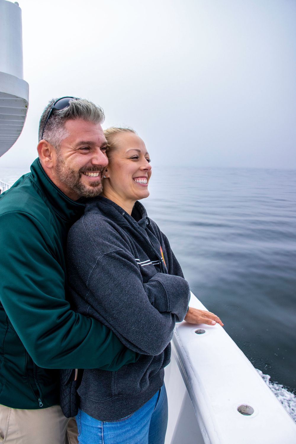 Couple enjoying a boat ride together on the ocean.