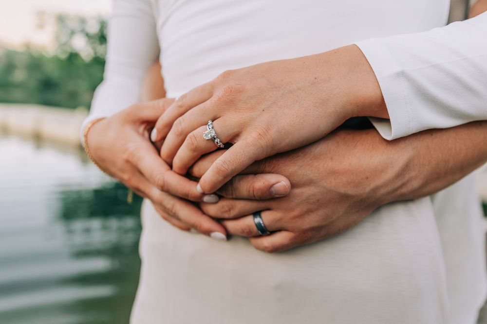 Close Up Wedding Rings Near Lake