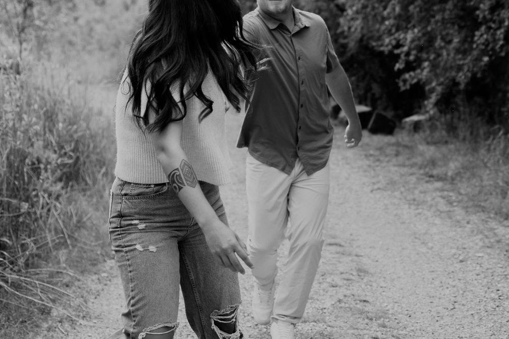 Playful Couple Walking Down Dirt Road