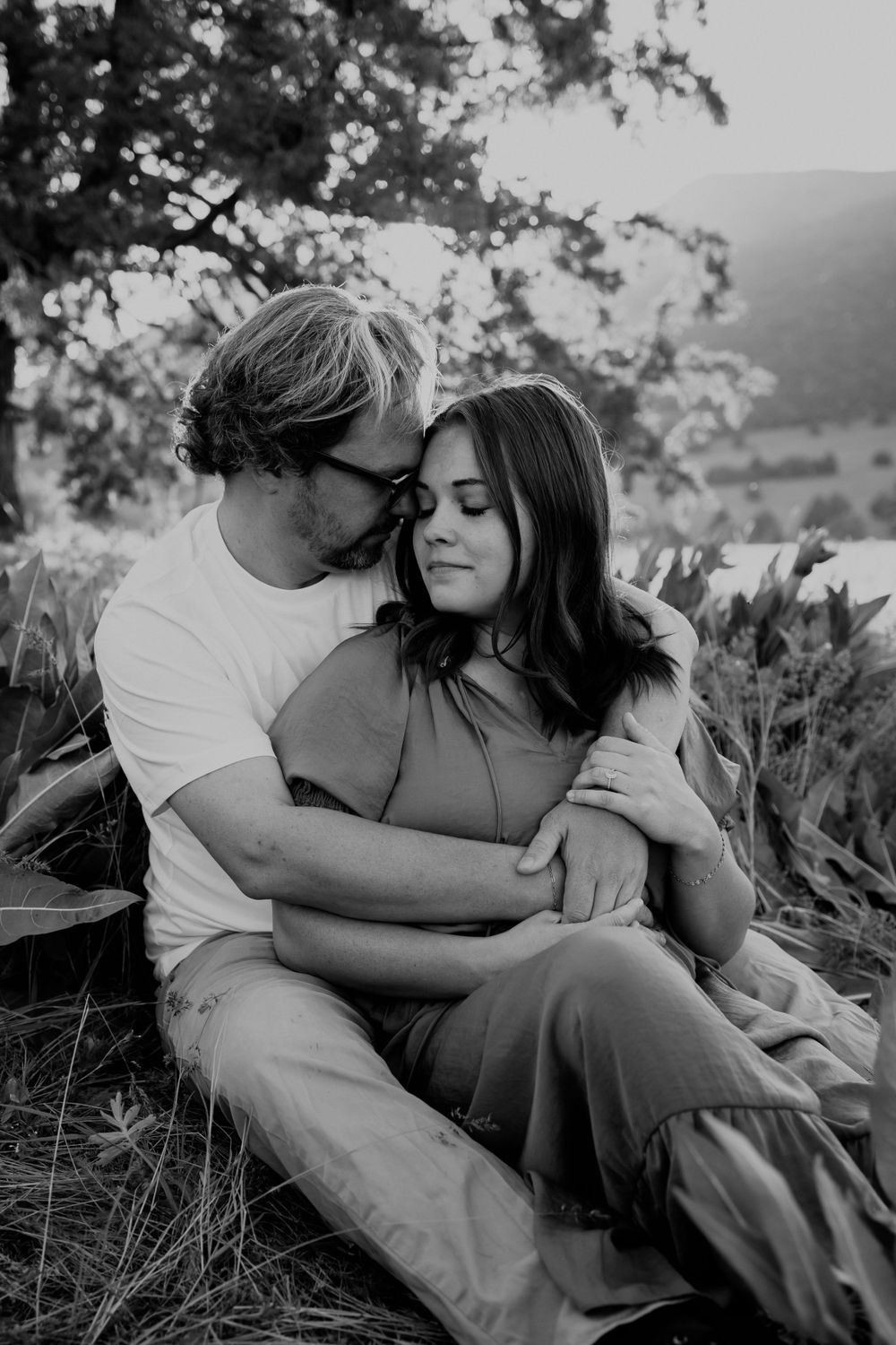 Couple Embracing Under Tree in Black and White