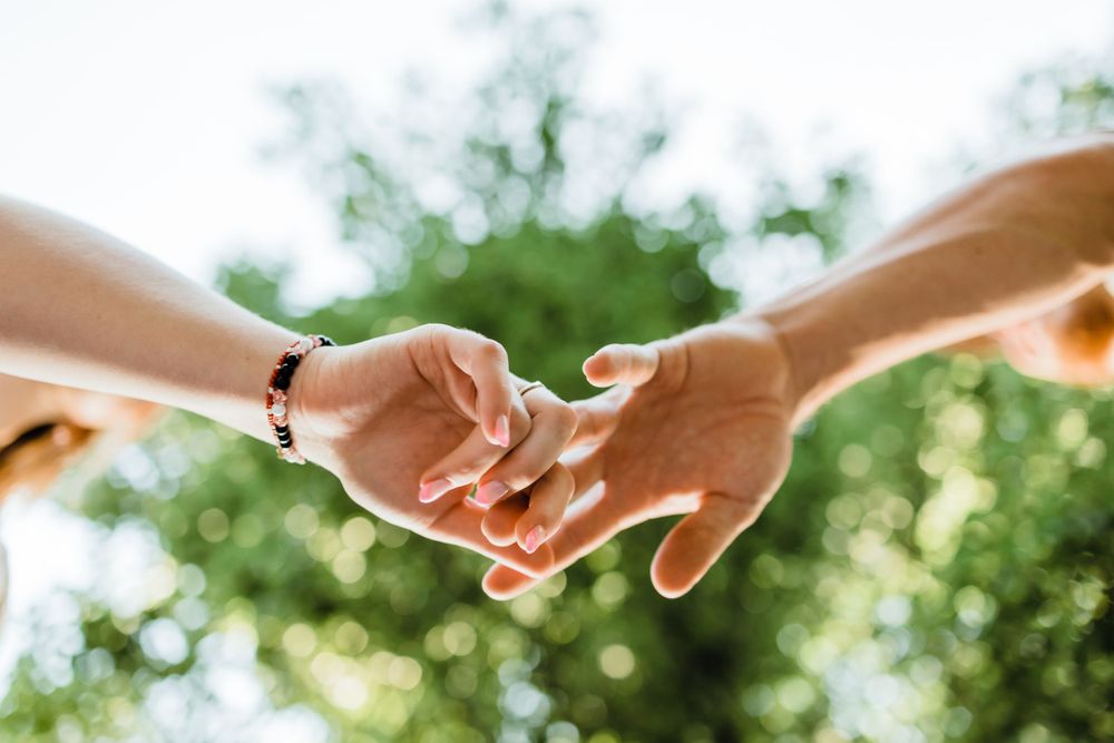 Couple Reaching for Each Others Hands