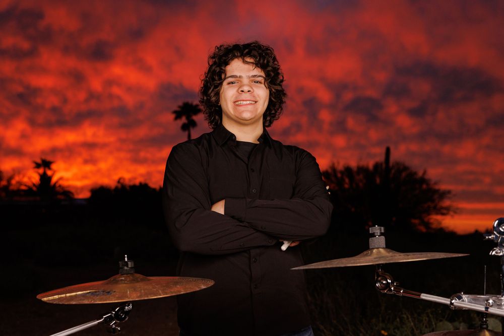 High school senior guy with drums at sunset in Tucson, photographed by Tucson Senior Photographer