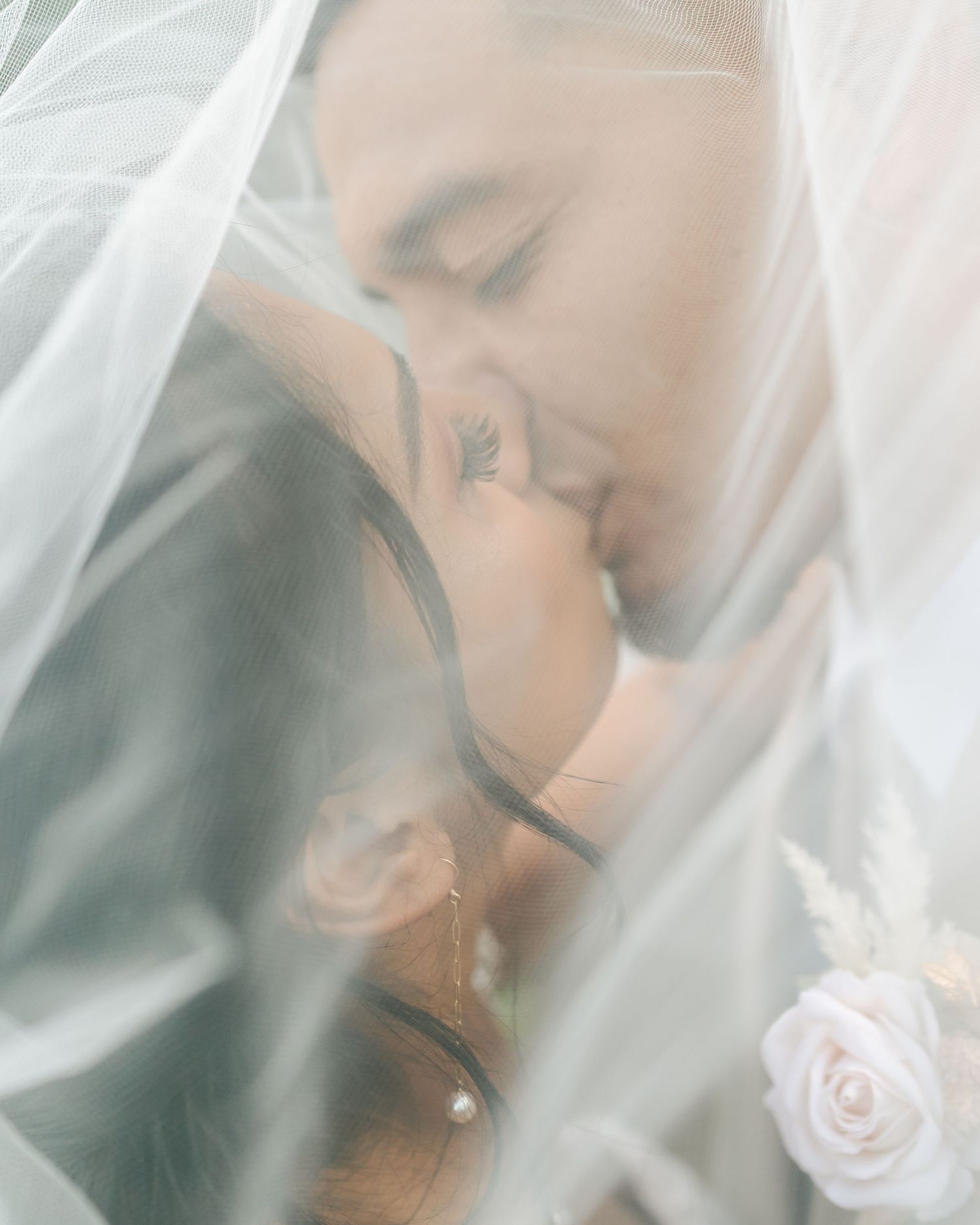 Oahu Hawaii Wedding under the veil kissing couple