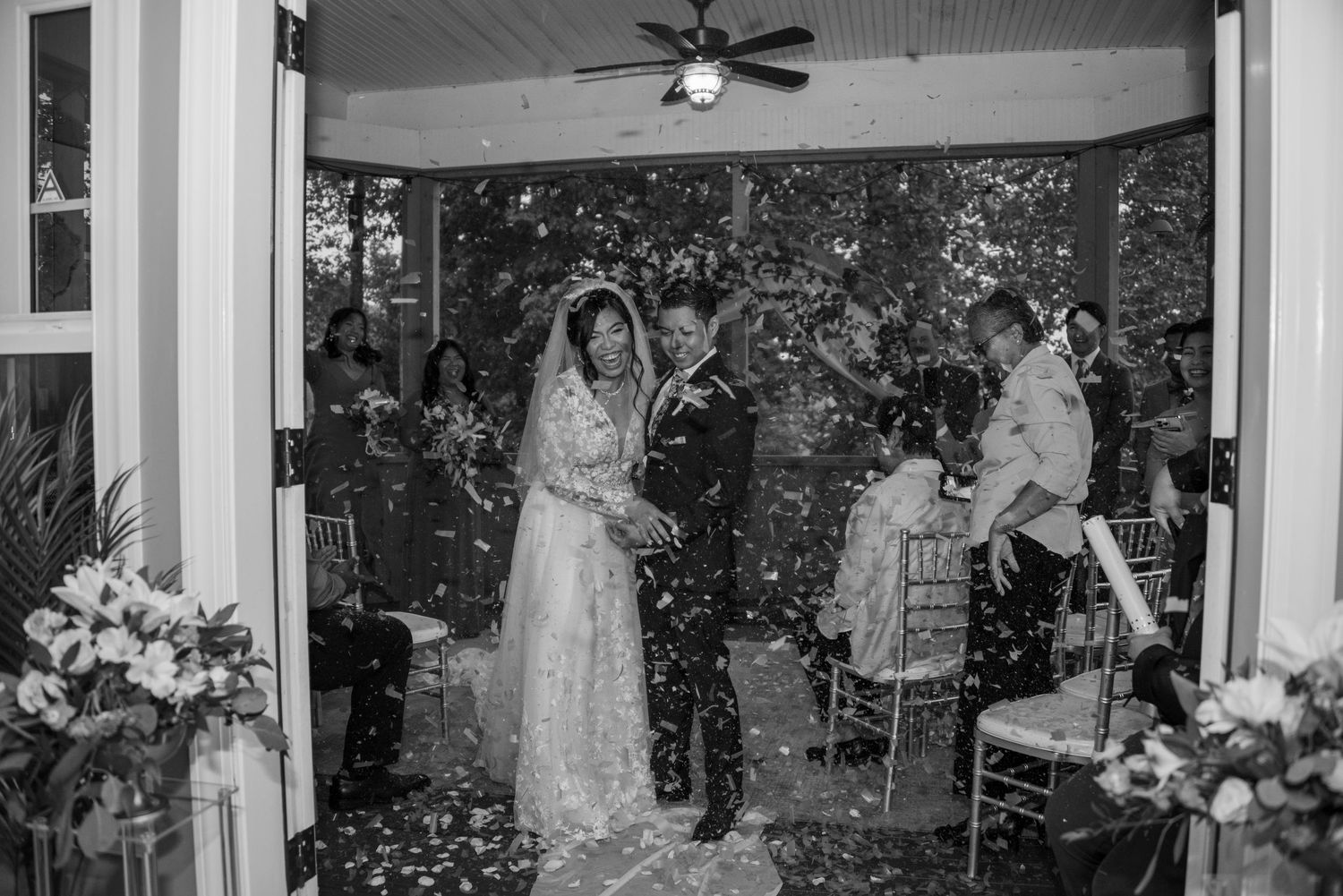 Bride and groom up close smiling with confetti