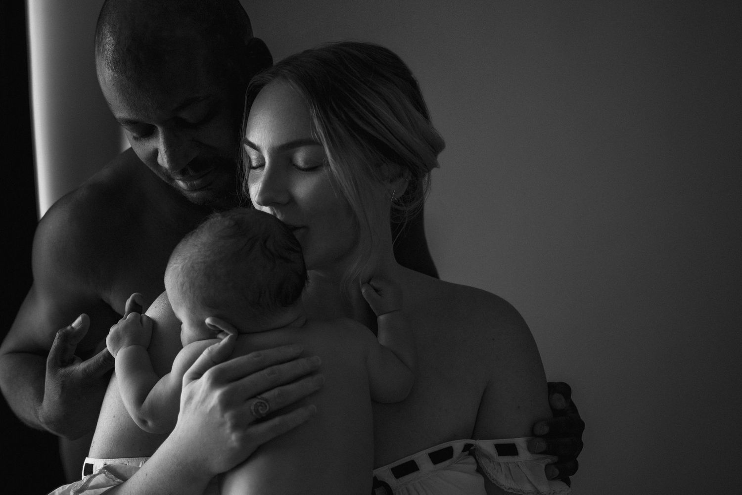 A series of black and white photographs showing intimate moments between couples embracing and kissing.