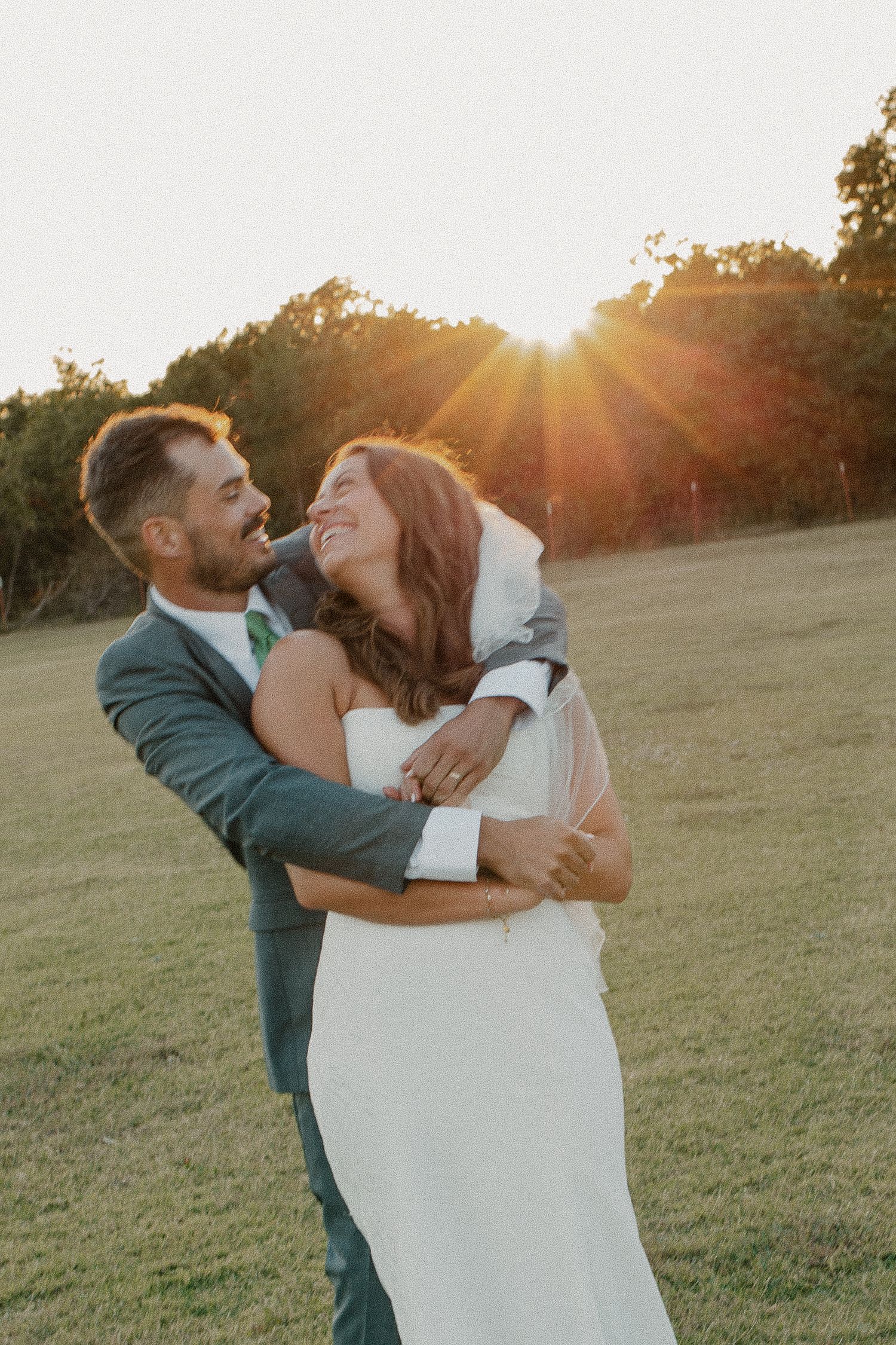 Photo of newly married couple hugging one another at sunset on a family farm in Edmond Oklahoma