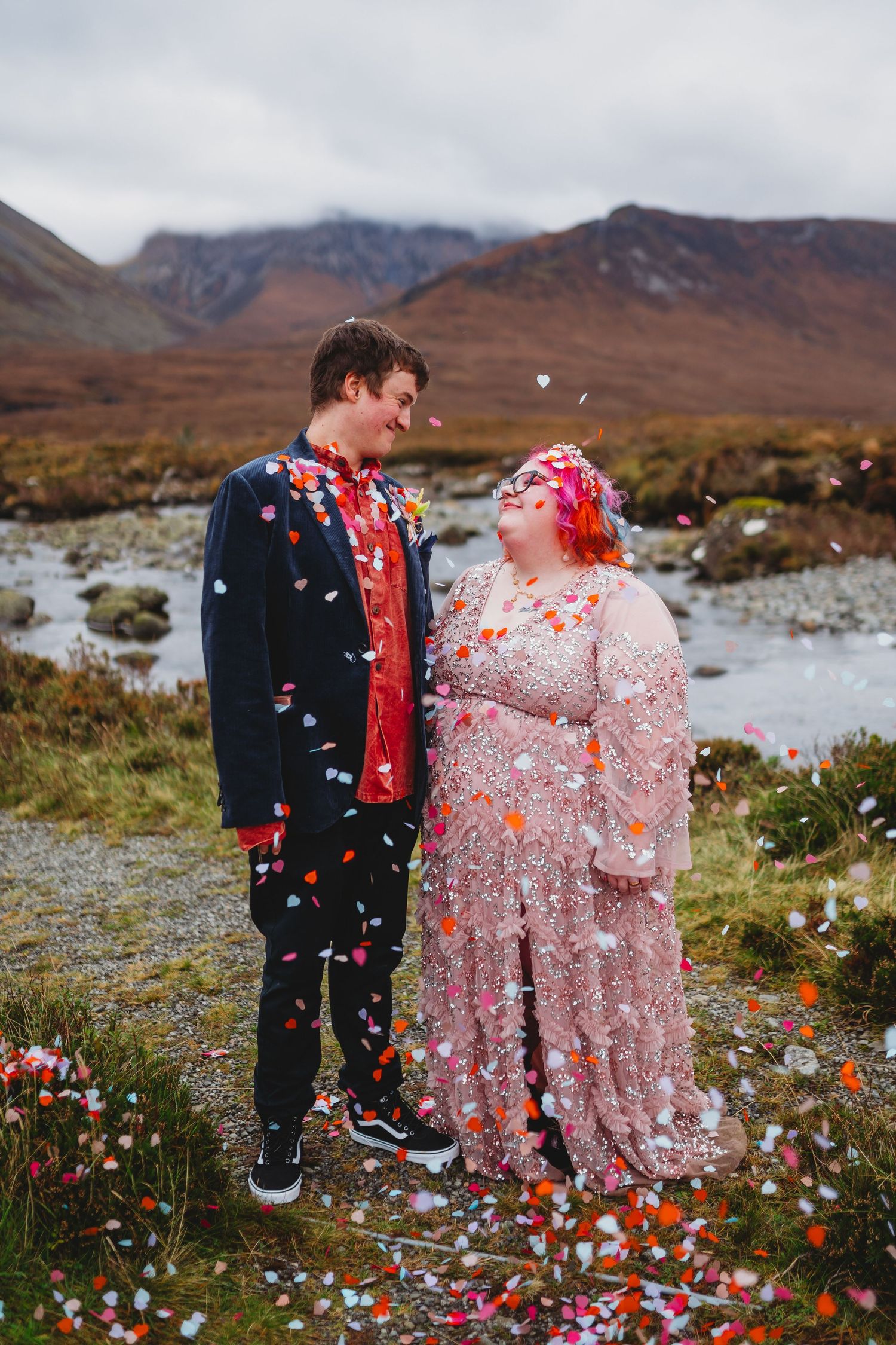 Wedding couple shares romantic moments in a misty outdoor setting with fall decor.
