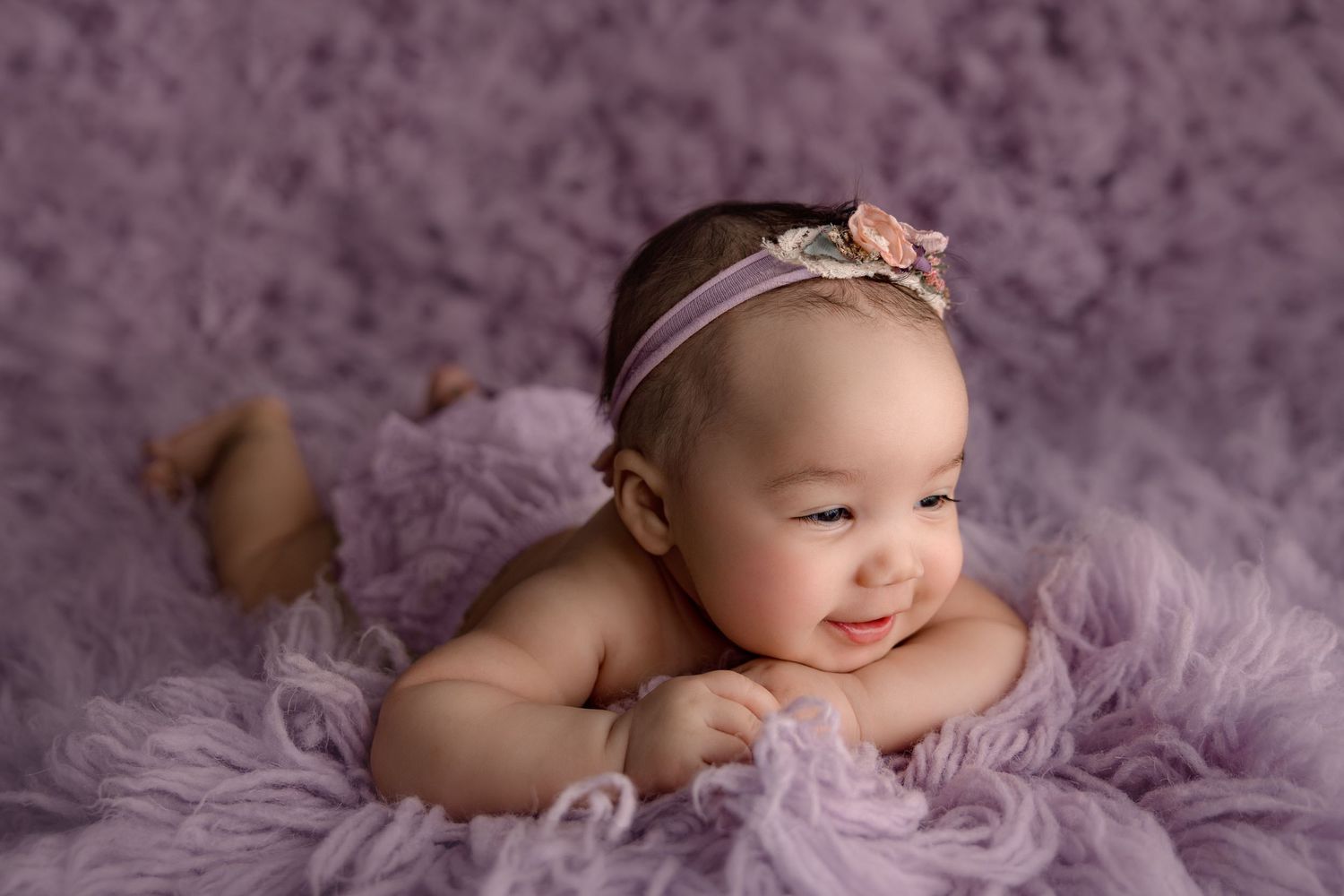 baby laying on tummy holding head up