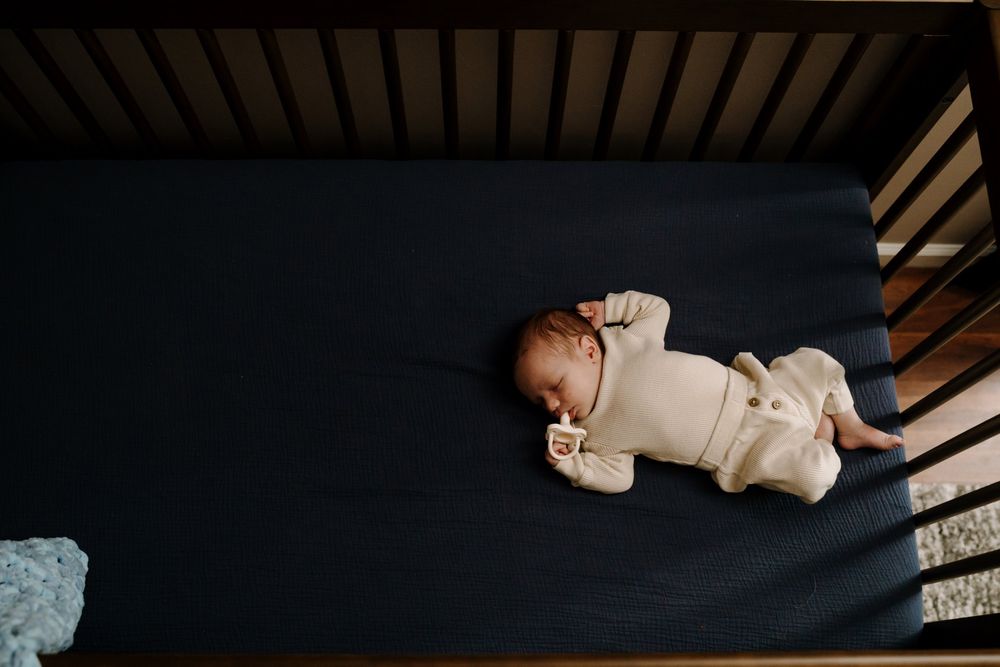 Newborn baby sleeps in crib