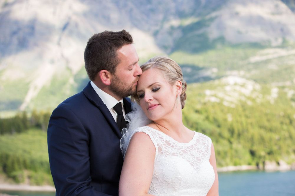 A romantic wedding photoshoot with stunning mountain vistas and lake scenery.
