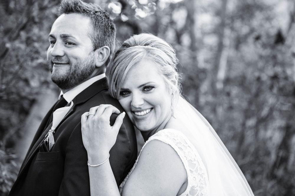 Black and white wedding portraits showing tender moments between newlyweds.
