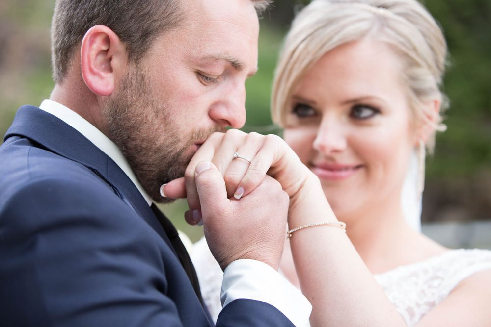 An intimate wedding moment captured against a scenic mountain landscape.