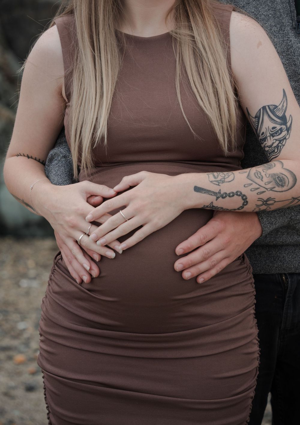 Pregnant belly with mums and dads hands on it