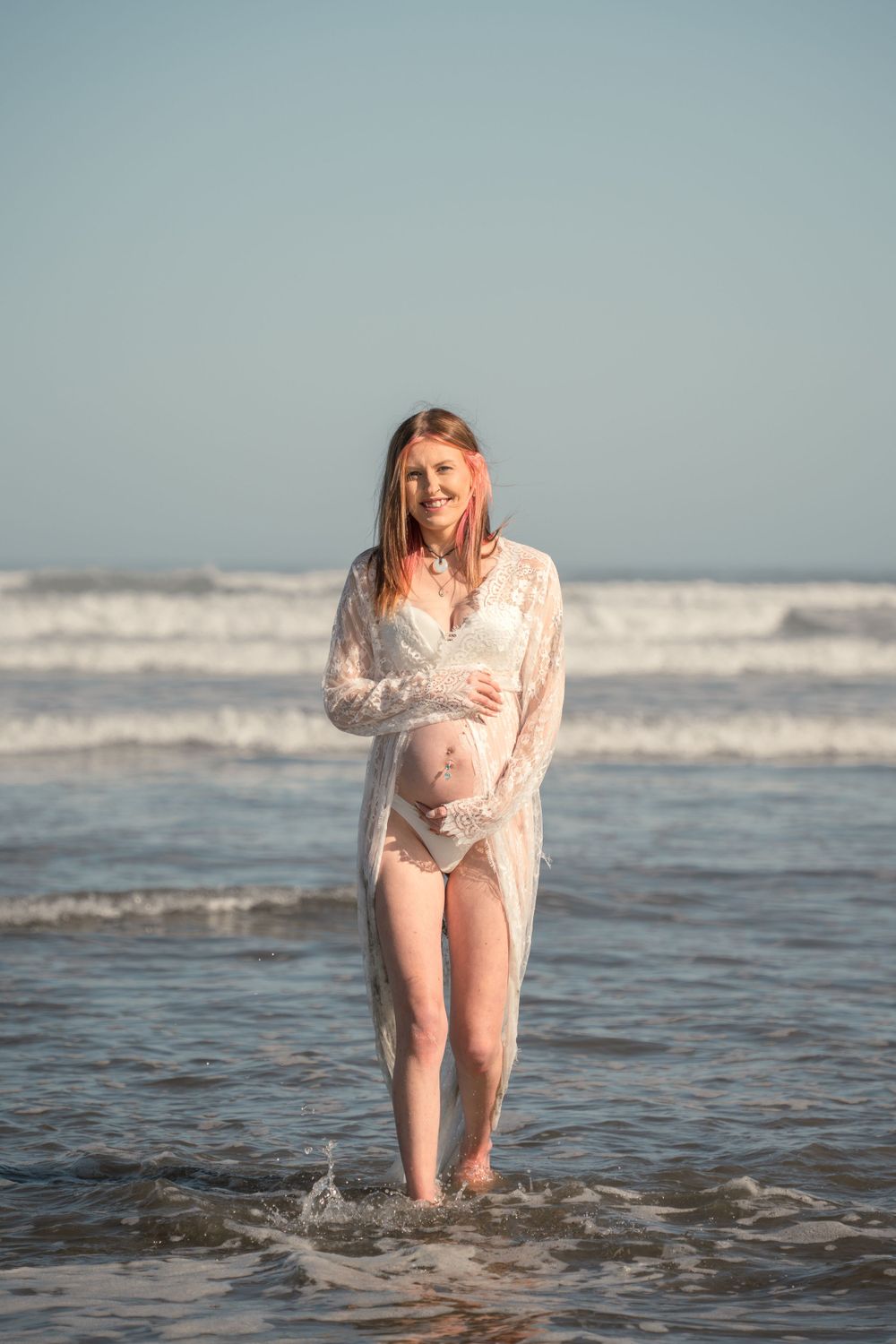 Pregnant woman walking in the water