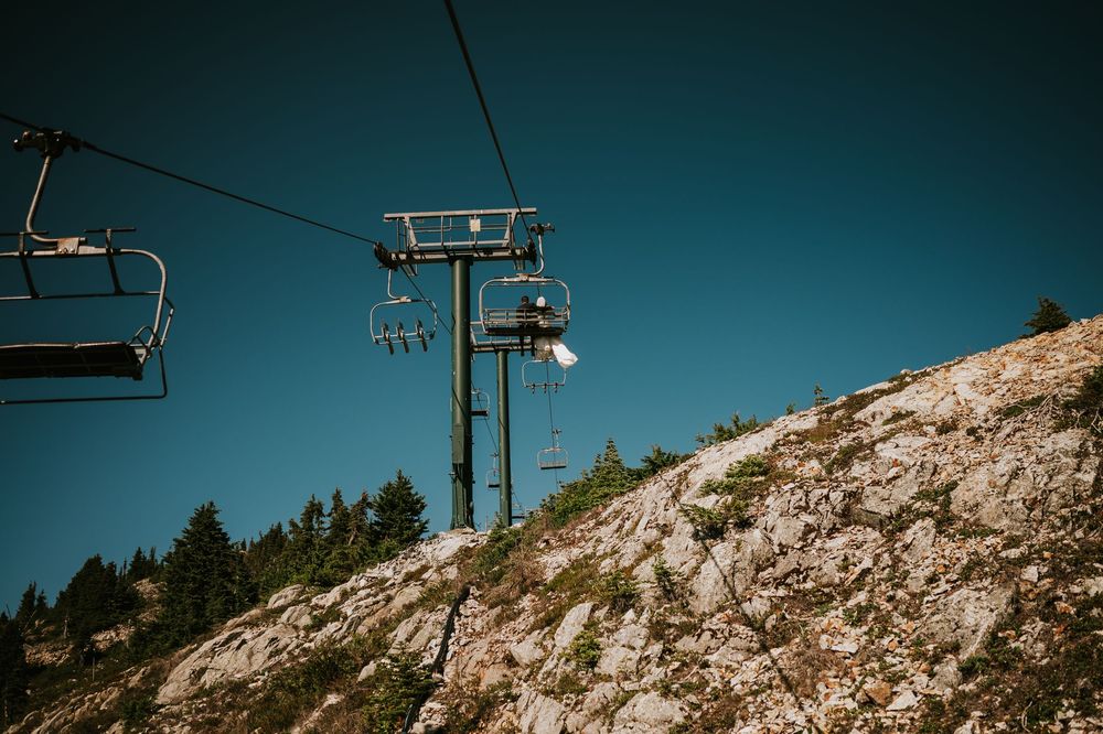 Vancouver Island Wedding photographer photography of couple on Mt Washington chairlift going up to take bridal photos on mountain
