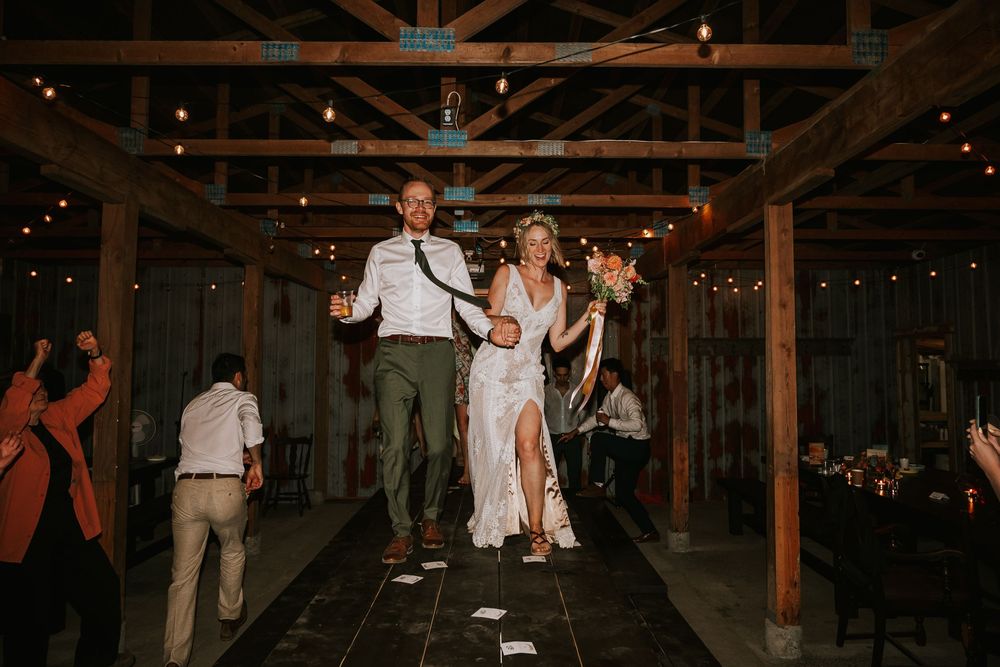 Vancouver Island Wedding photographer photography of couple dancing on tables in barn at Smith Lake Farm, Merville, Campbell River