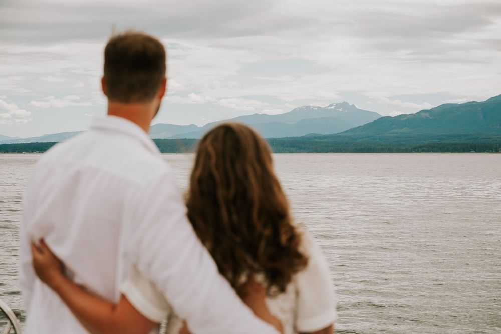 Vancouver Island Wedding photographer photography of couple elopement on sail boat looking at mountains