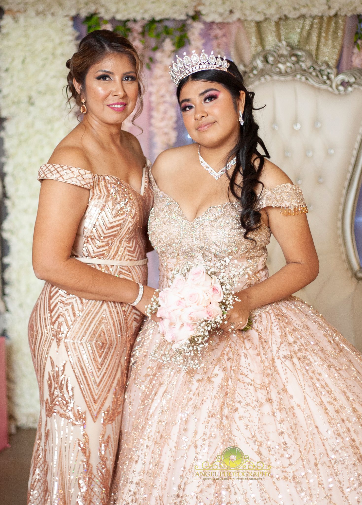 Two people in formal gowns pose together at a special event.