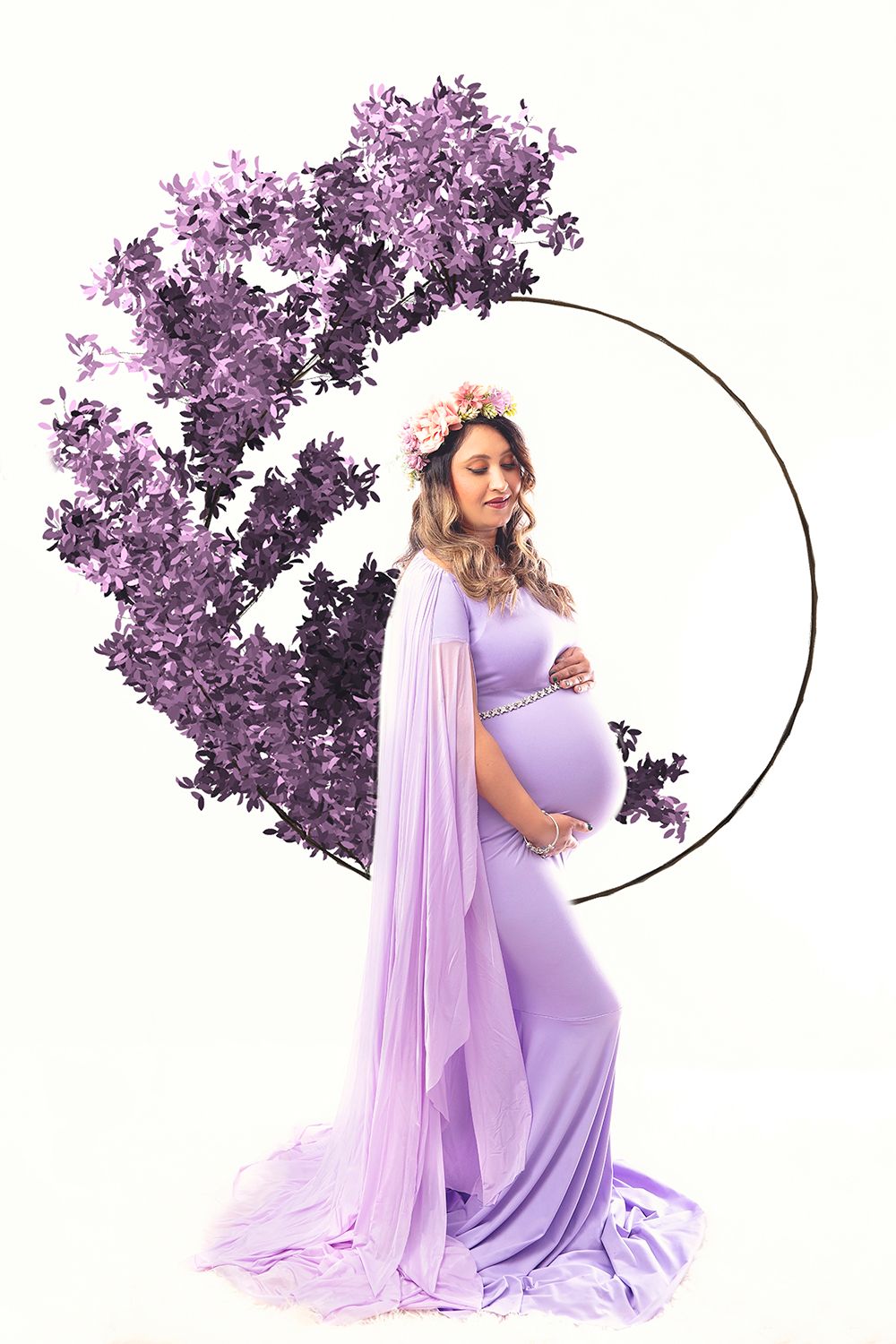 Pregnant woman in lavender gown with floral crown poses beside purple floral circular backdrop.