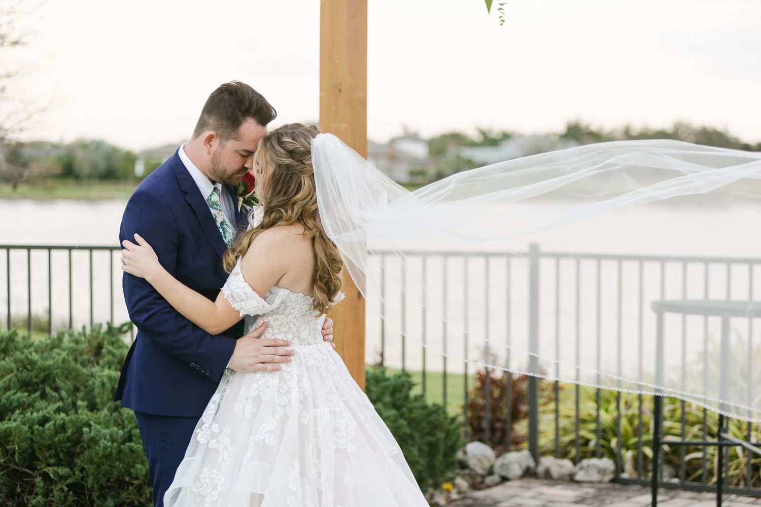 Tropical lakeside wedding by Clearwater wedding photography. Veil blowing in the wind.